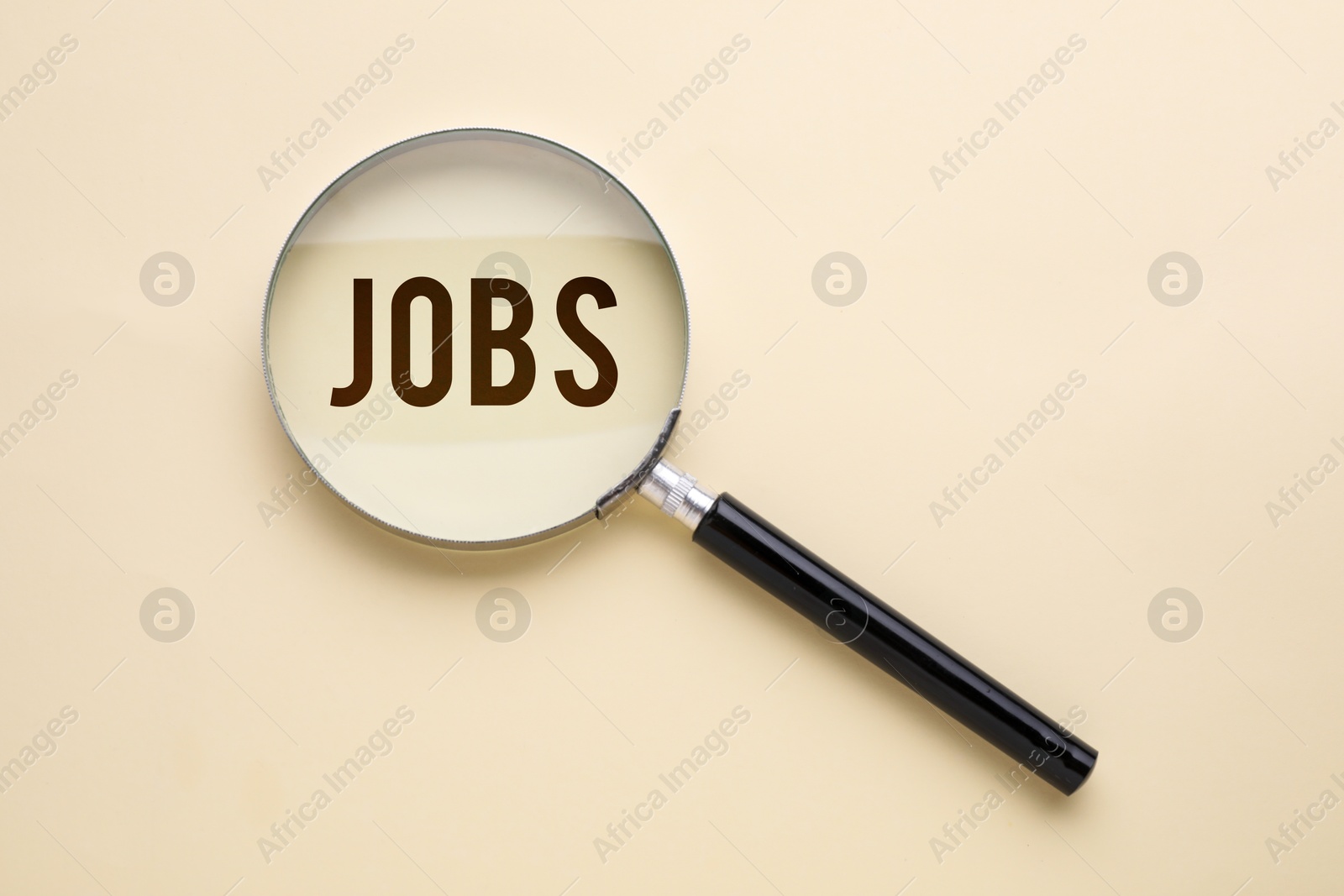 Image of Job search concept. Word on beige background, view through magnifying glass