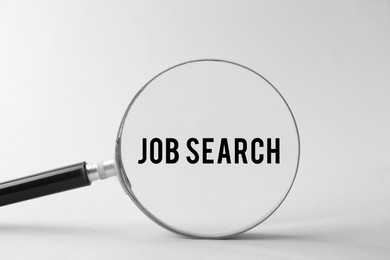 Image of Job Search words on white background, view through magnifying glass