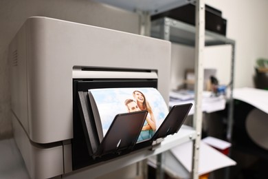 Photo of Modern printer with colorful photo indoors, closeup