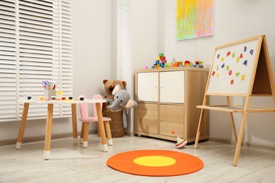 Photo of Table with paints and different toys in child's room