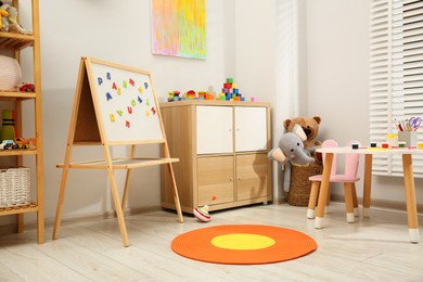 Photo of Table with paints and different toys in child's room