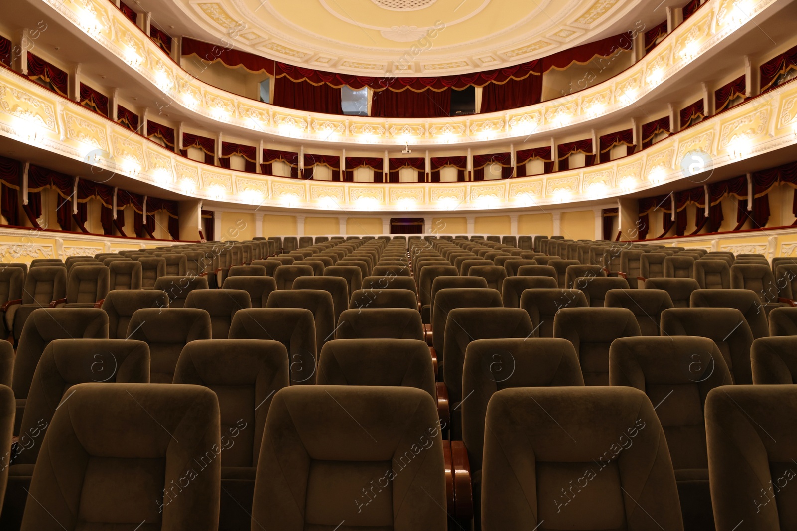 Photo of Rows of gray comfortable seats in theatre