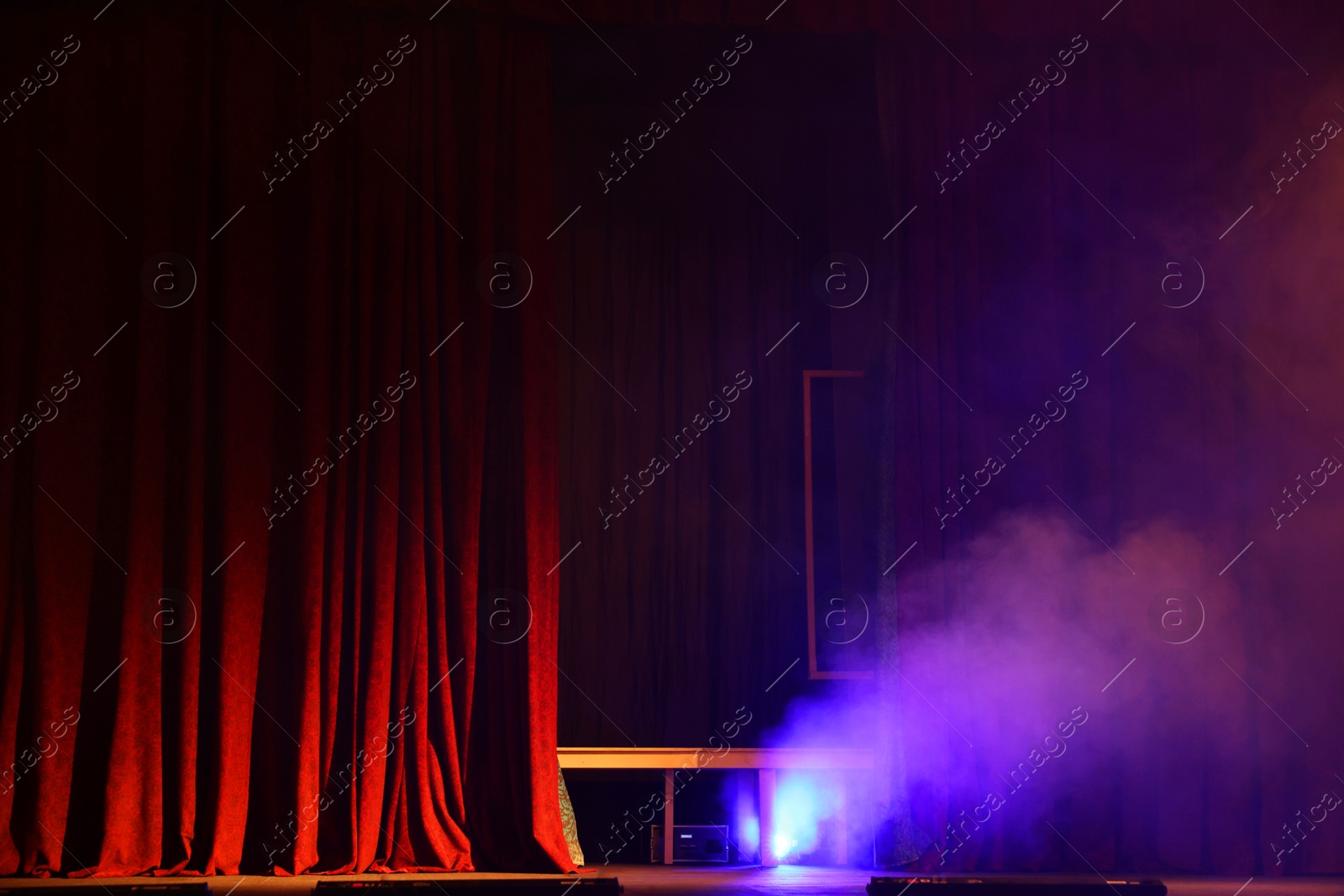 Photo of Professional spotlight and smoke on stage in theatre