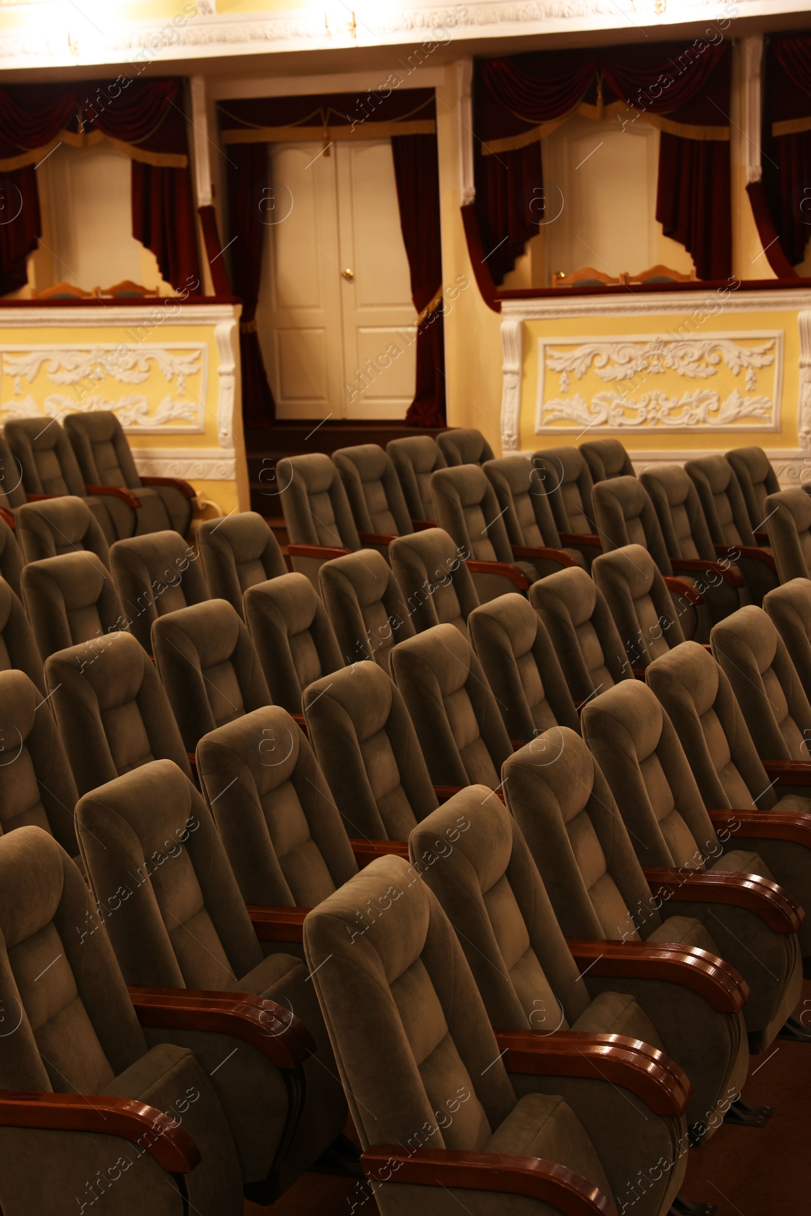 Photo of Rows of gray comfortable seats in theatre