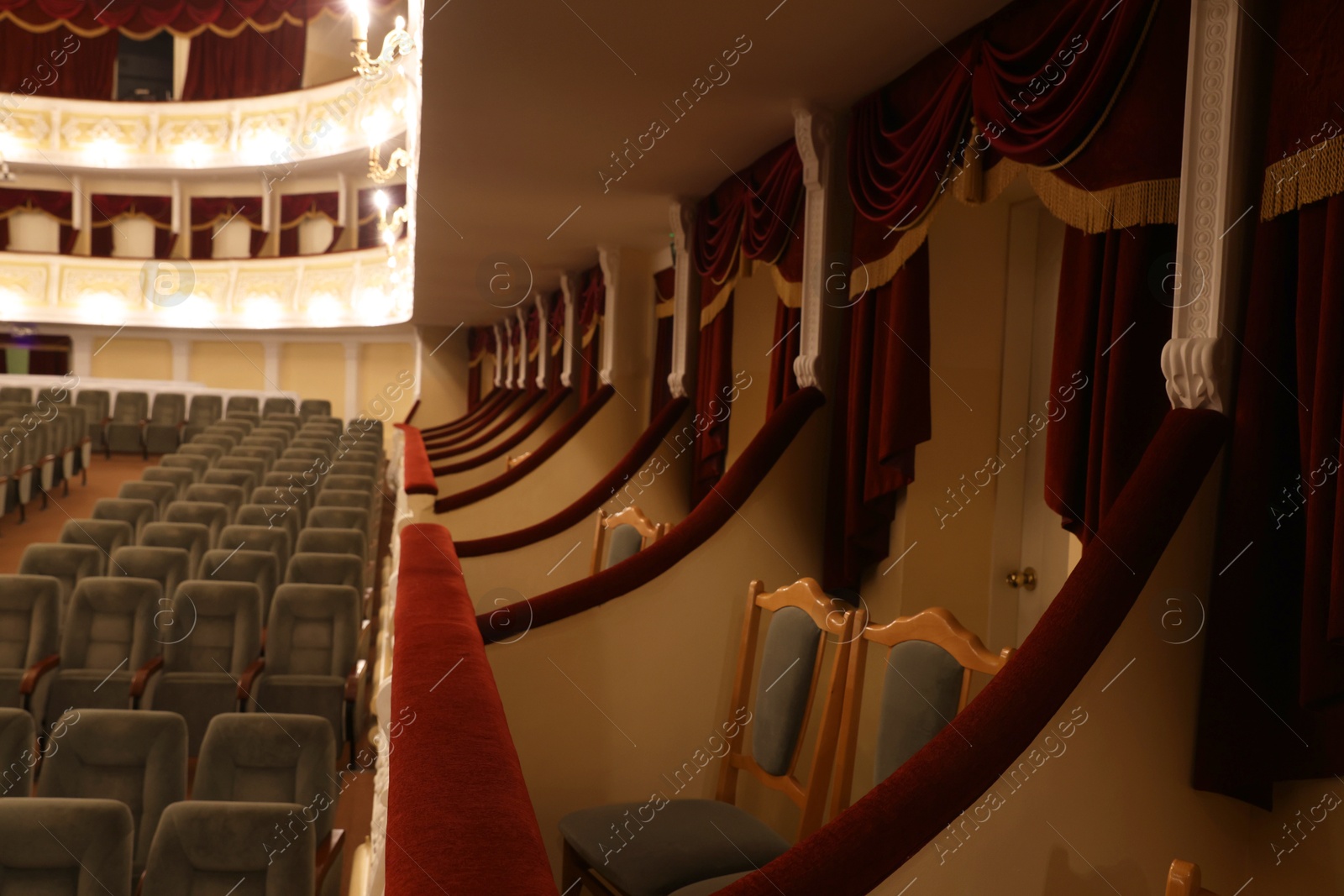 Photo of Empty gray comfortable seats in theatre, selective focus