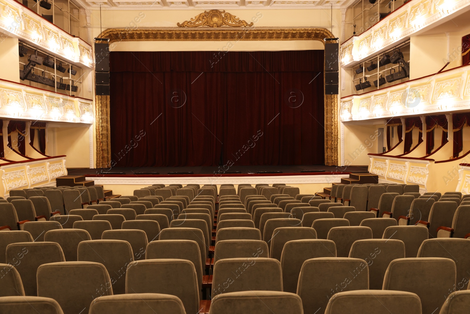 Photo of Rows of gray comfortable seats in theatre