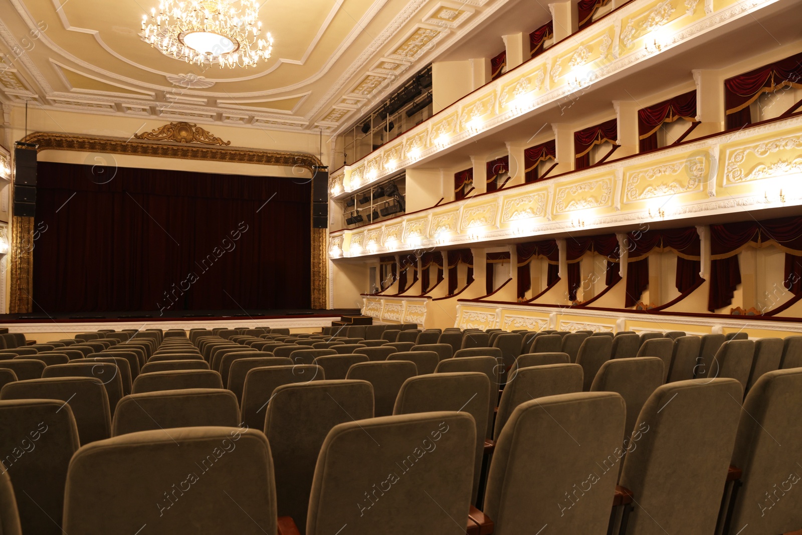 Photo of Rows of gray comfortable seats in theatre