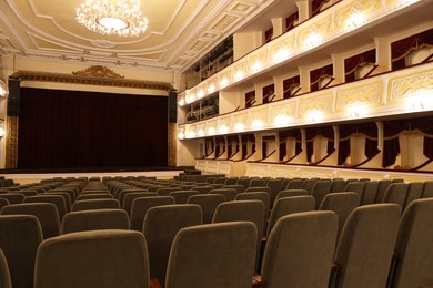 Photo of Rows of gray comfortable seats in theatre