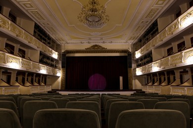 Photo of Theatre interior with stage and rows of comfortable seats