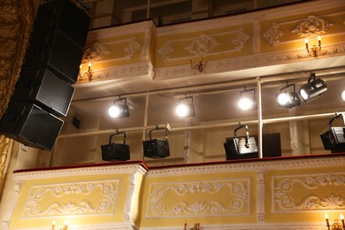 Photo of Professional spotlights in theatre, low angle view