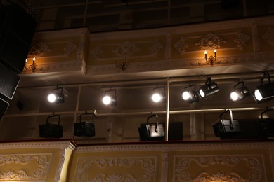 Photo of Professional spotlights in theatre, low angle view