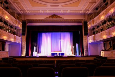 Photo of Theatre interior with stage and rows of comfortable seats