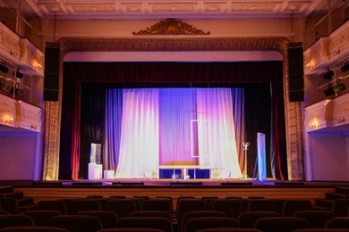 Photo of Theatre interior with stage and rows of comfortable seats