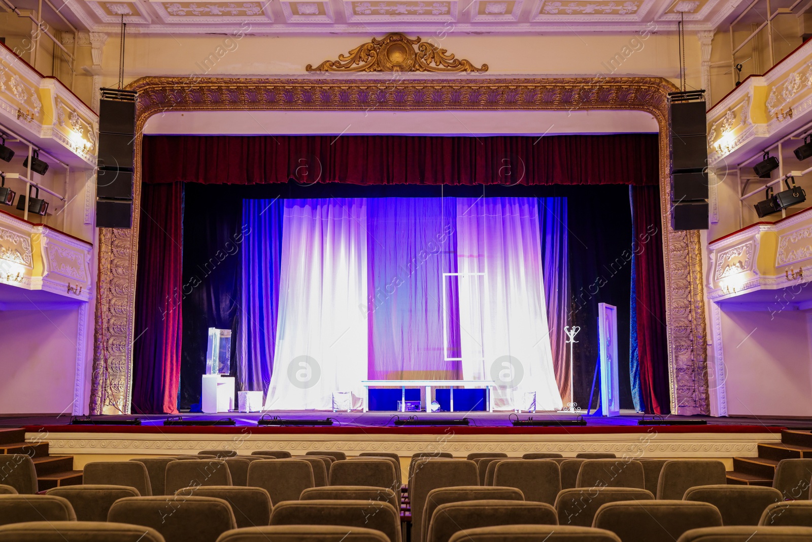 Photo of Theatre interior with stage and rows of comfortable seats