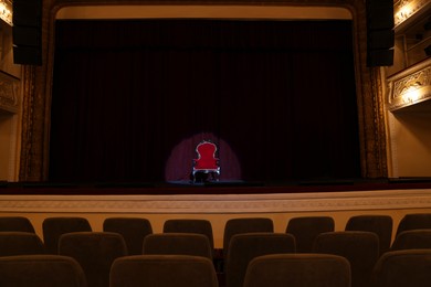 Photo of Vintage red armchair on stage in theatre