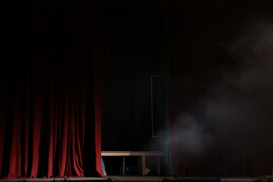 Photo of Smoke on dark stage in modern theatre