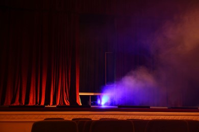 Photo of Professional spotlight and smoke on stage in theatre