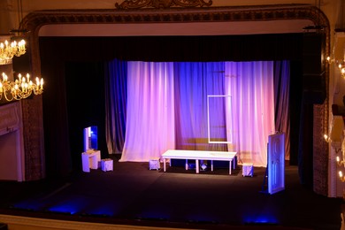 Photo of Different furniture and other decorations on stage in theatre