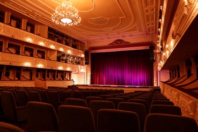 Photo of Theatre interior with stage and rows of comfortable seats