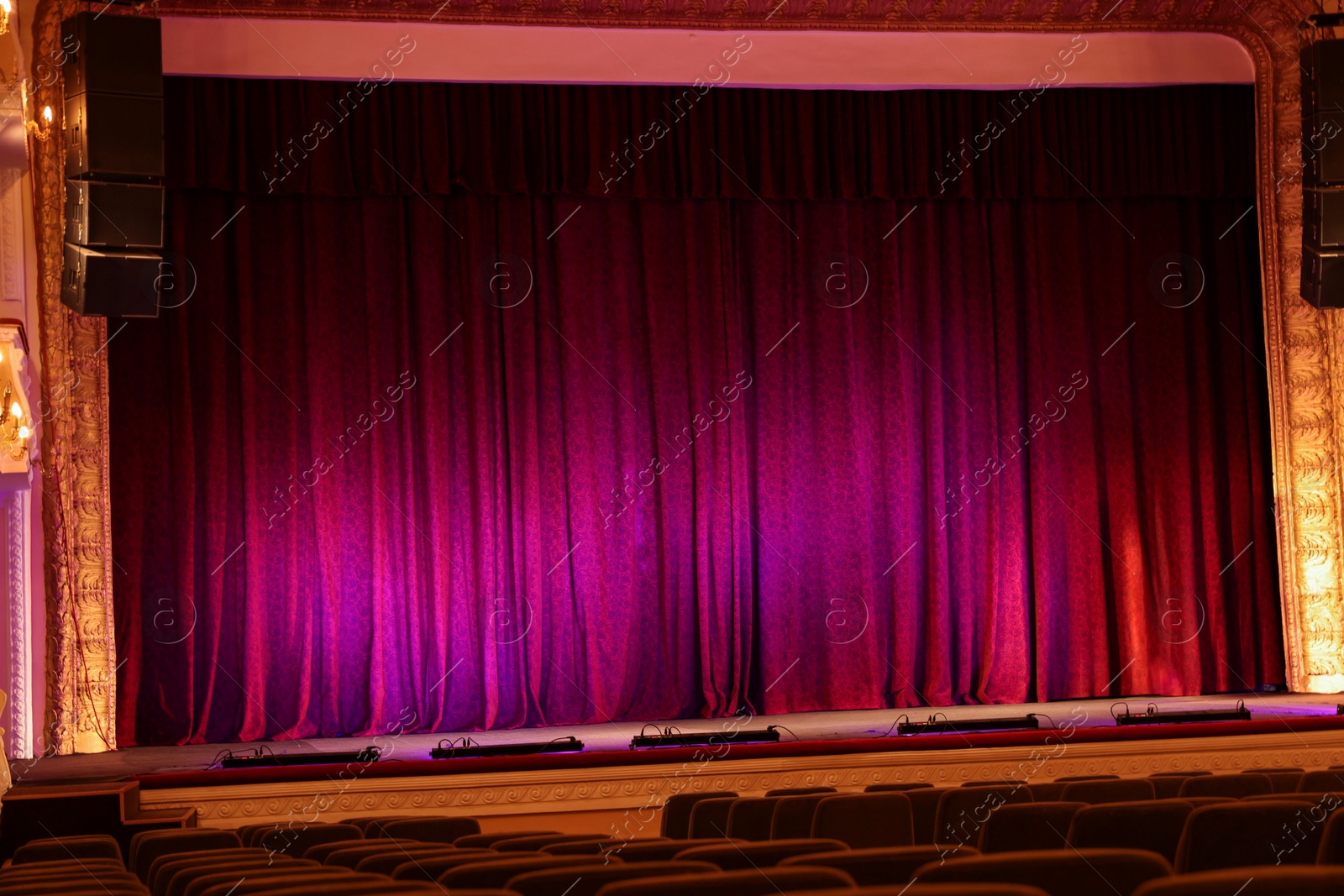 Photo of Elegant closed curtains on stage in theatre