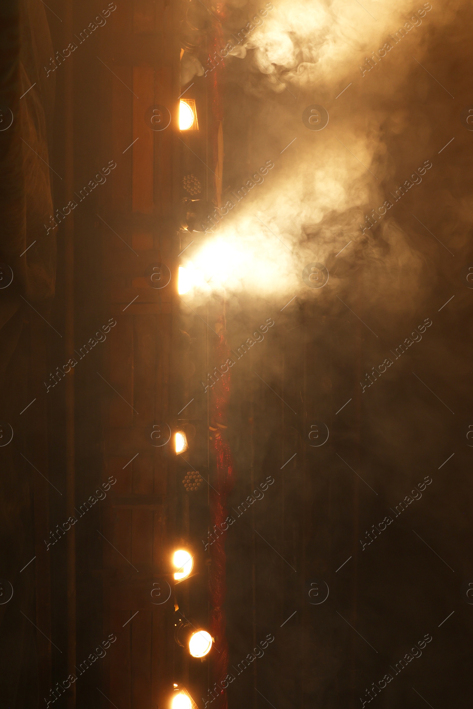 Photo of Professional spotlights and smoke on stage in theatre