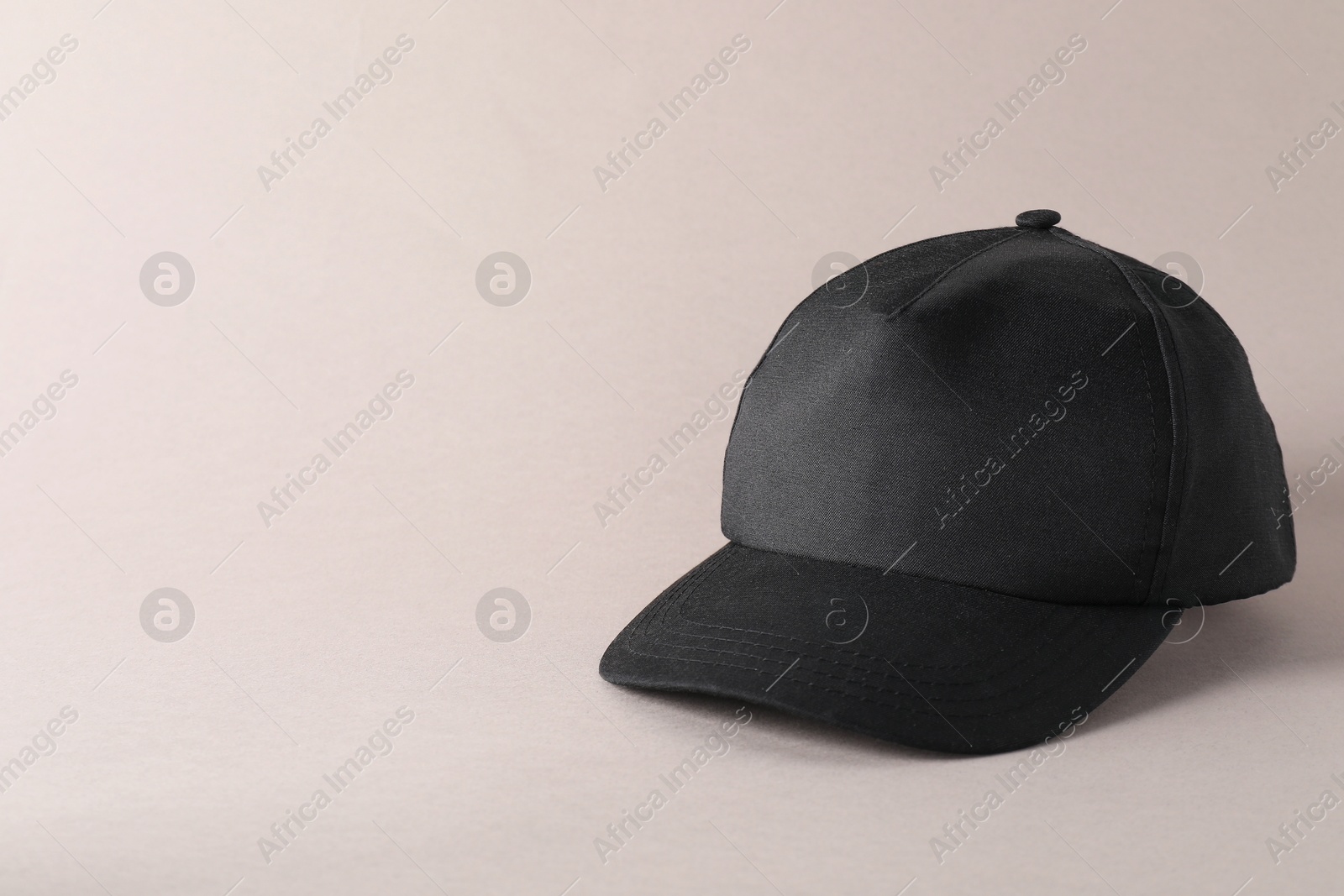 Photo of Stylish black baseball cap on light grey background. Mockup for design