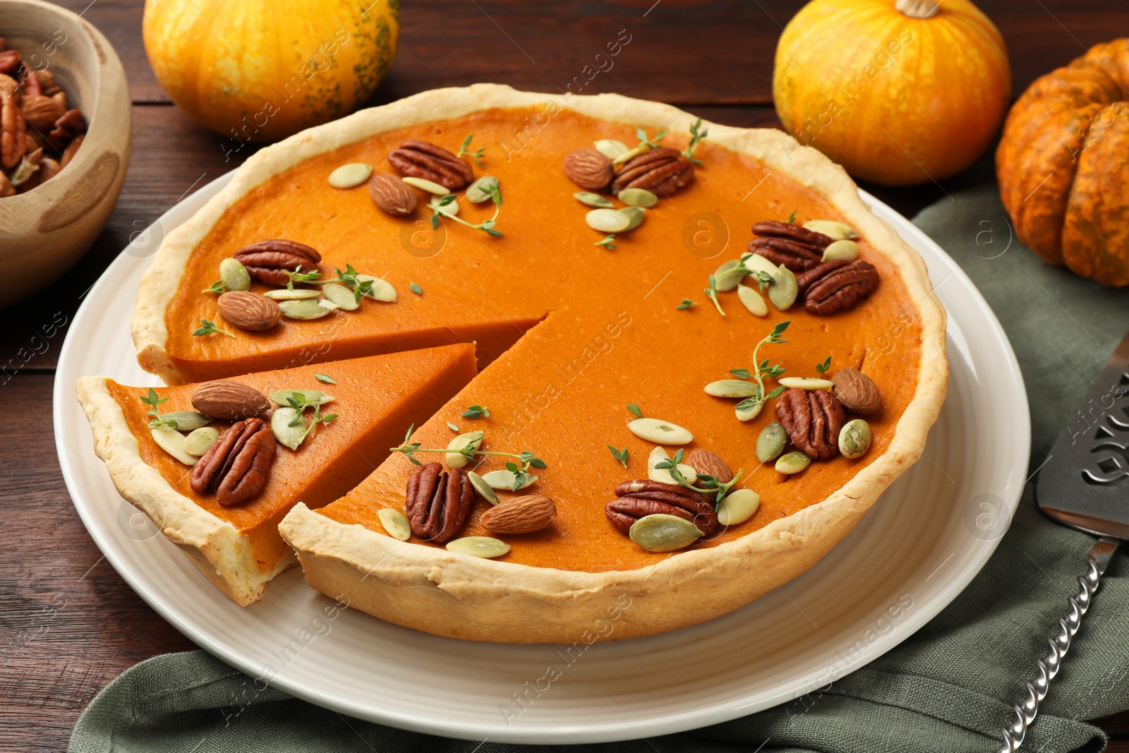 Photo of Tasty homemade pumpkin pie served on wooden table, closeup