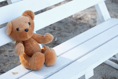 Photo of Lonely teddy bear on bench in park