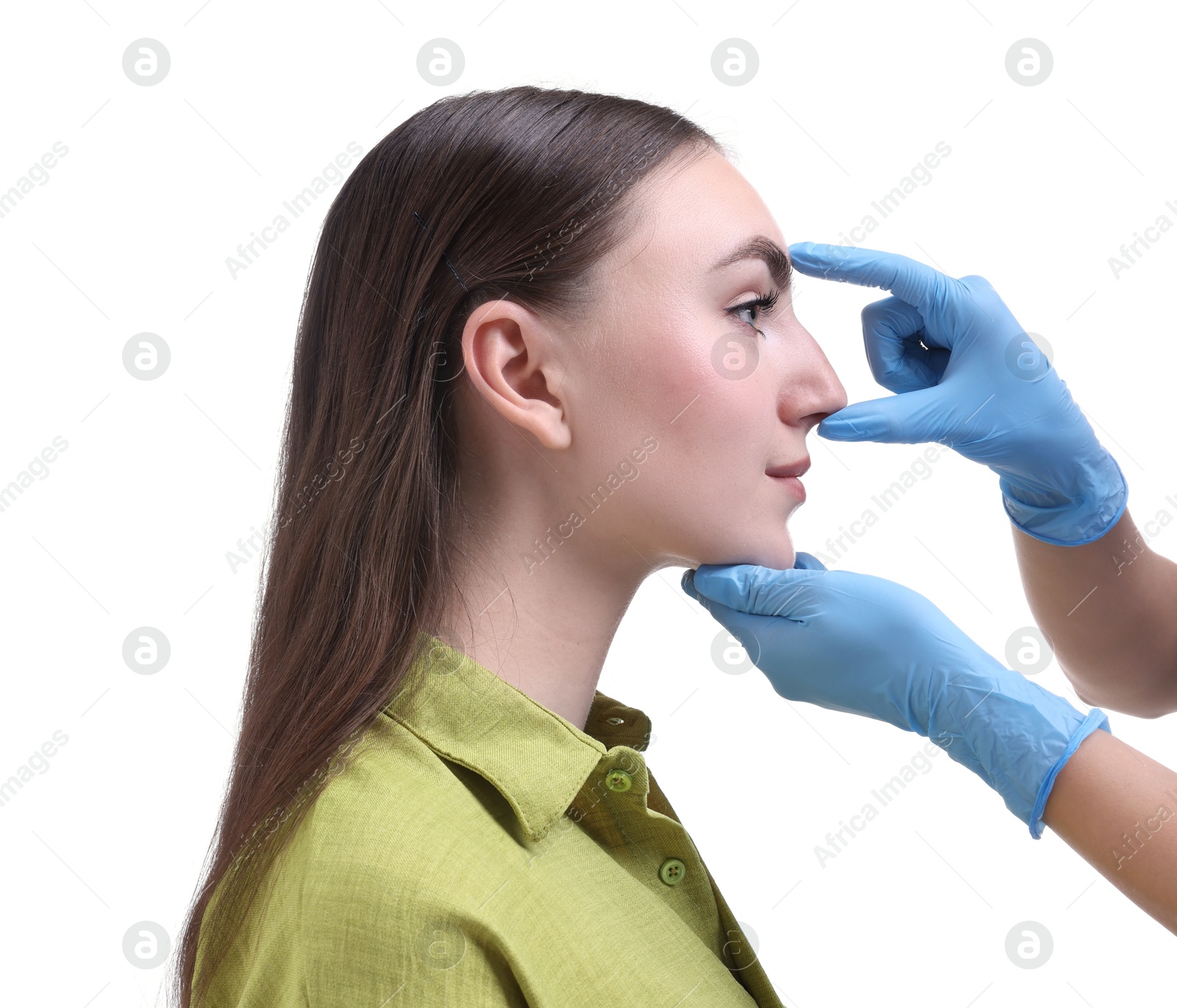 Photo of Doctor checking patient's nose before plastic surgery operation on white background, closeup