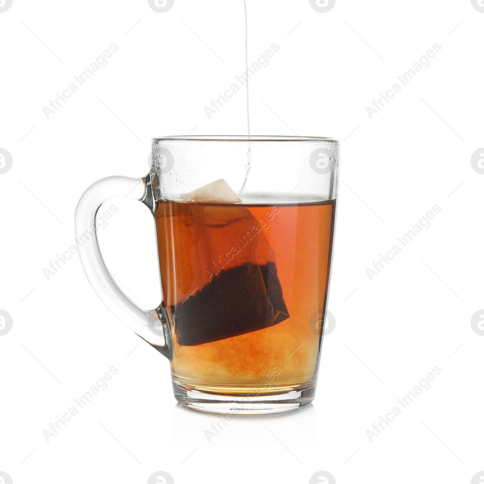 Photo of Cup with teabag isolated on white. Brewing aromatic tea