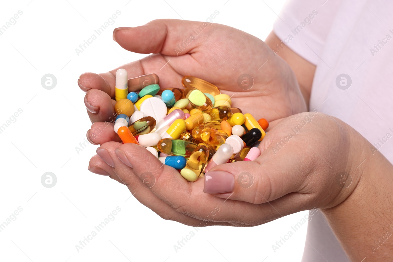 Photo of Plus size woman holding pile of weight loss supplements on white background, closeup