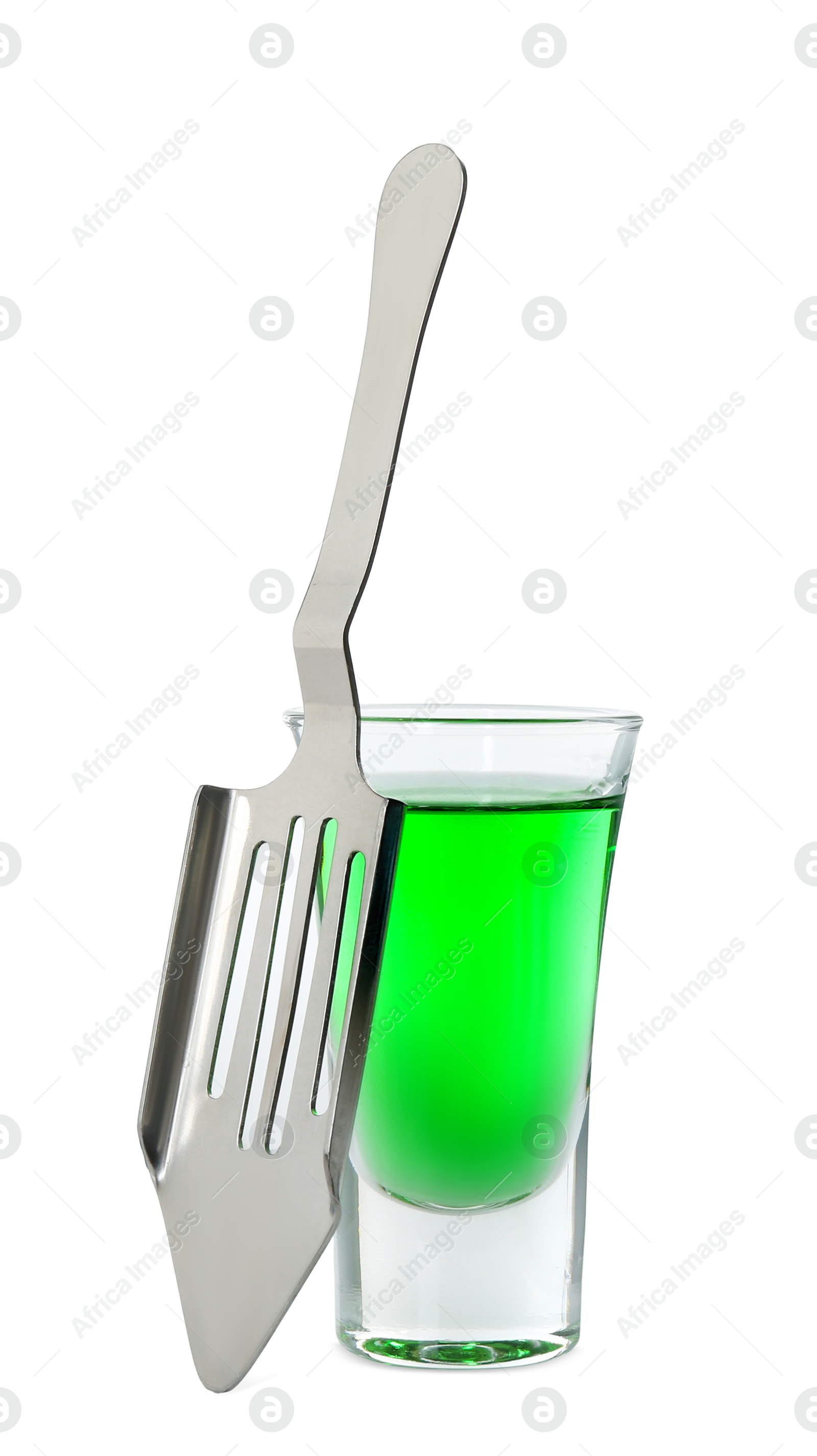 Photo of Absinthe in shot glass and slotted spoon isolated on white