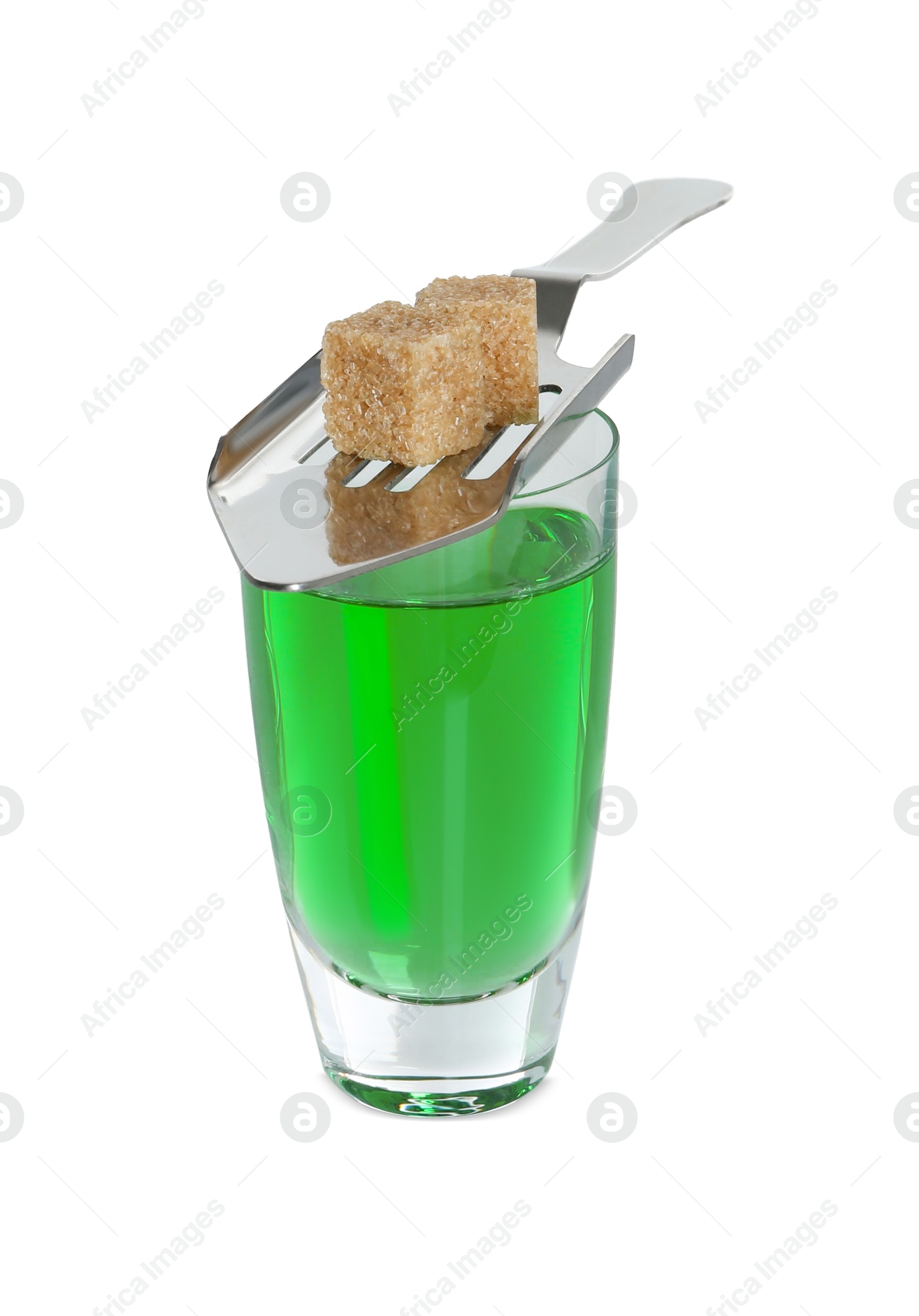 Photo of Absinthe in shot glass, brown sugar cubes and slotted spoon isolated on white