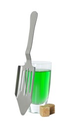 Photo of Absinthe in shot glass, brown sugar cubes and slotted spoon isolated on white