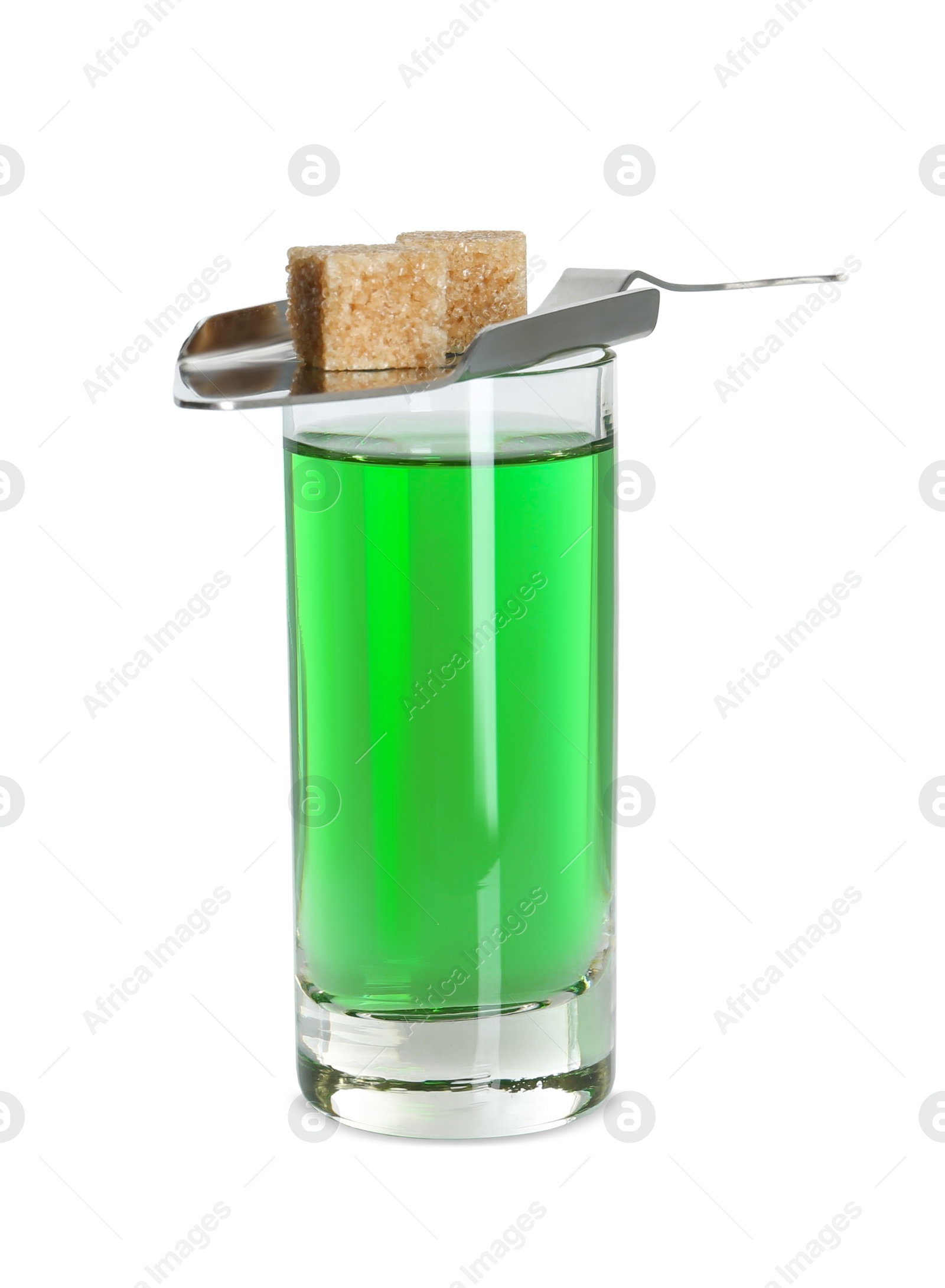 Photo of Absinthe in shot glass, brown sugar cubes and slotted spoon isolated on white