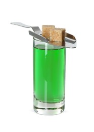 Photo of Absinthe in shot glass, brown sugar cubes and slotted spoon isolated on white