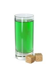 Photo of Absinthe in shot glass and brown sugar cubes isolated on white