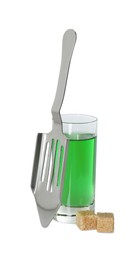 Photo of Absinthe in shot glass, brown sugar cubes and slotted spoon isolated on white