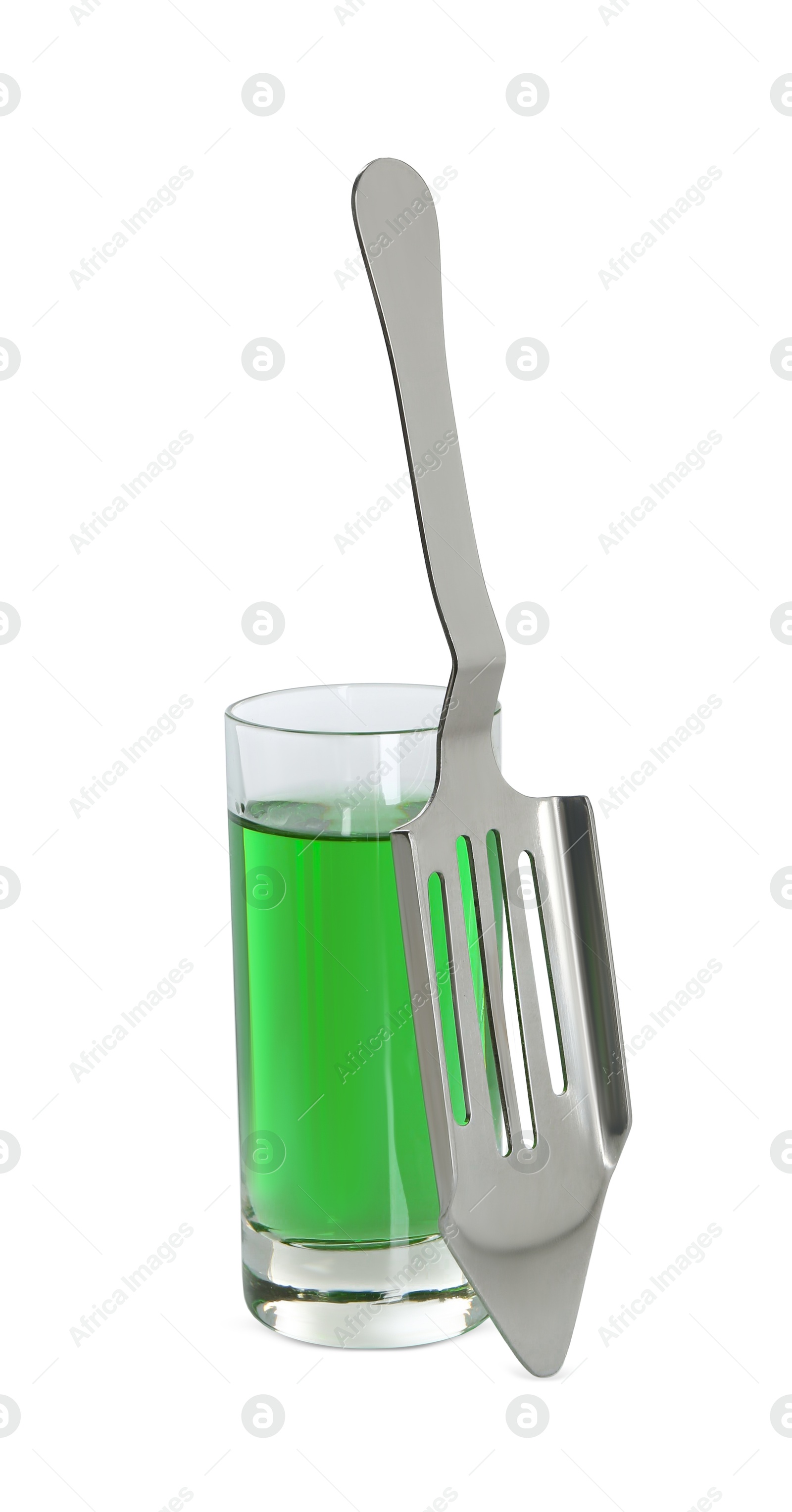 Photo of Absinthe in shot glass and slotted spoon isolated on white