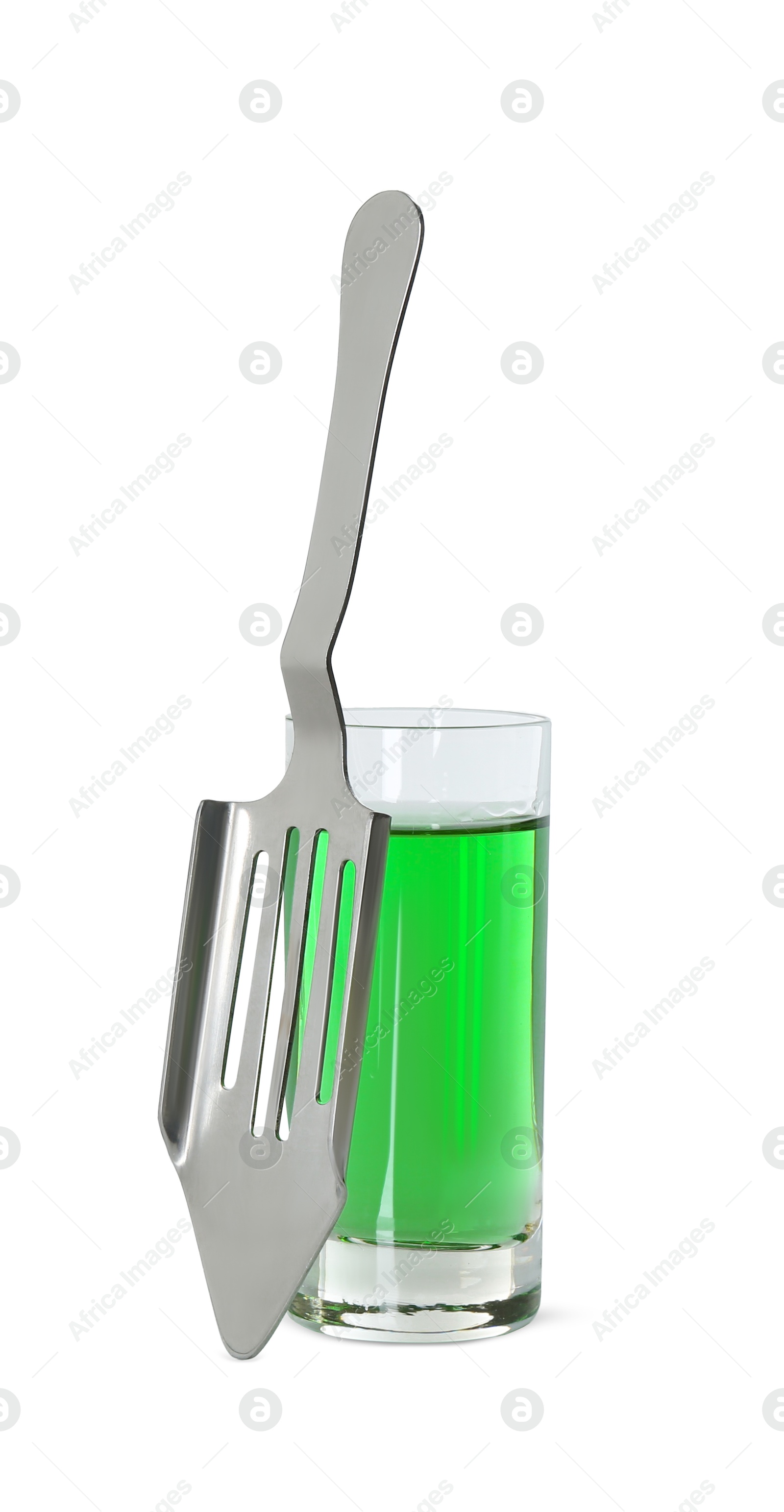 Photo of Absinthe in shot glass and slotted spoon isolated on white