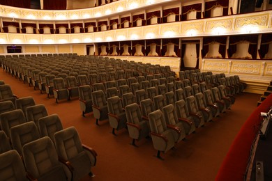 Photo of Rows of gray comfortable seats in theatre