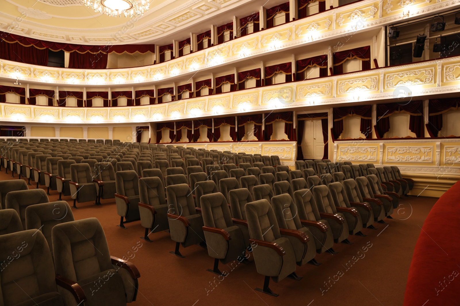 Photo of Rows of gray comfortable seats in theatre