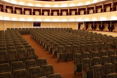 Photo of Rows of gray comfortable seats in theatre