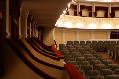 Photo of Rows of gray comfortable seats in theatre