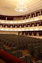 Photo of Rows of gray comfortable seats in theatre