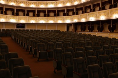 Photo of Rows of gray comfortable seats in theatre