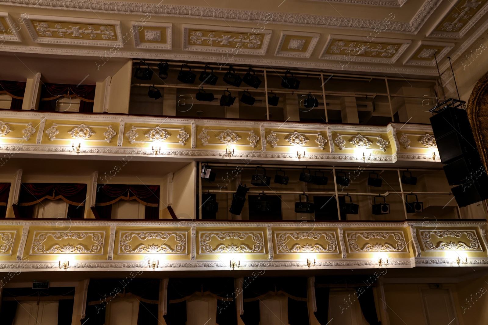 Photo of Balconies with vintage wall lamps and spotlights in theatre