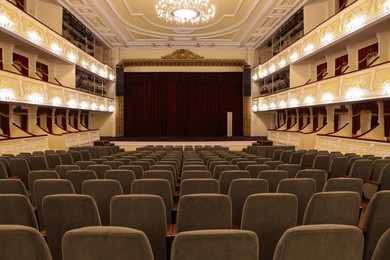 Photo of Rows of gray comfortable seats in theatre