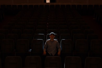 Photo of Portrait of young man applauding in theatre