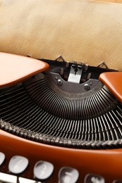 Photo of Vintage typewriter with sheet of parchment paper, closeup